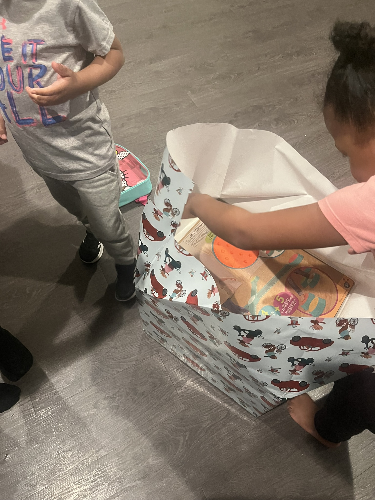 Children opening a large sensory gift together