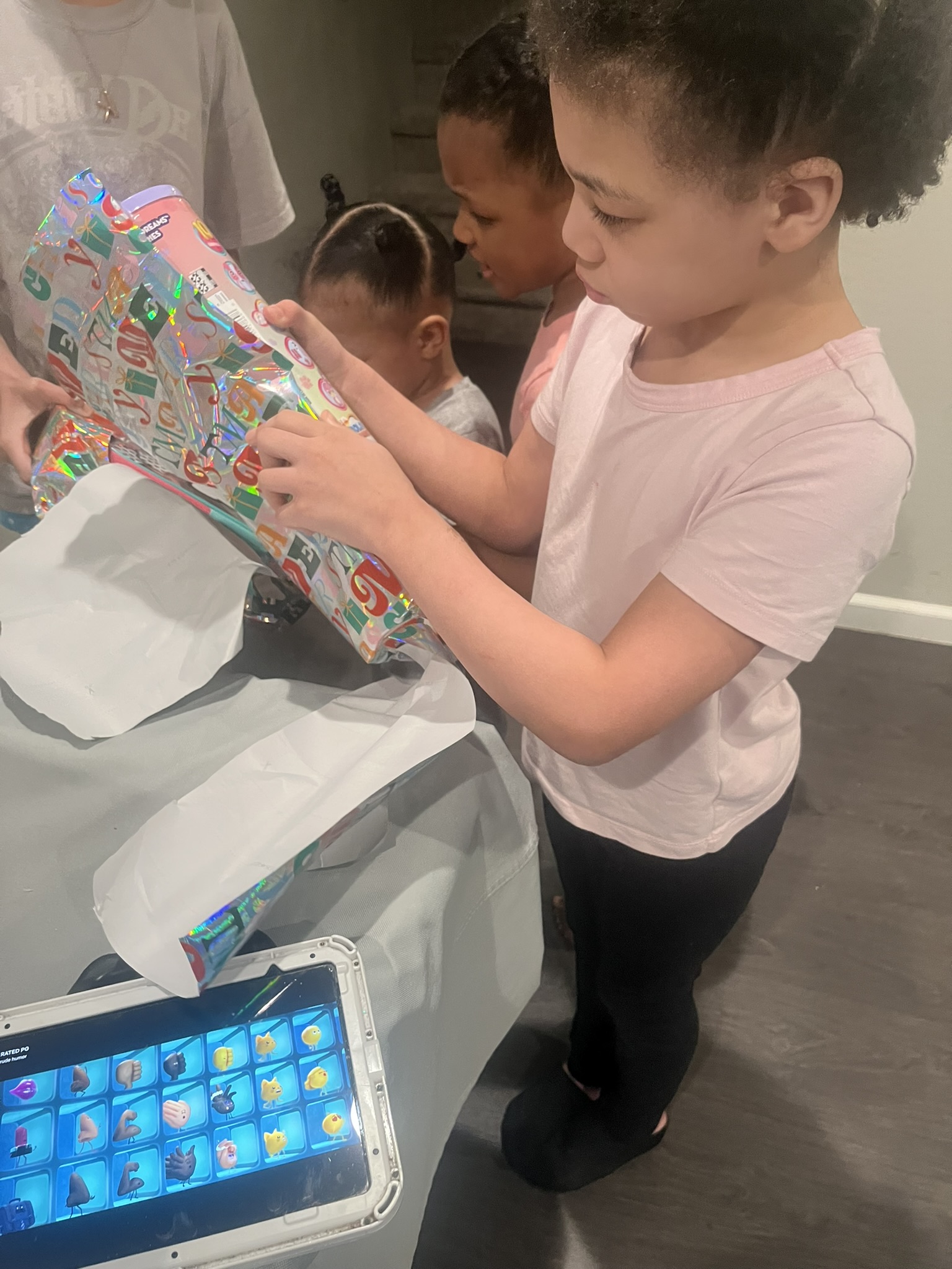 Children opening individually wrapped Christmas presents