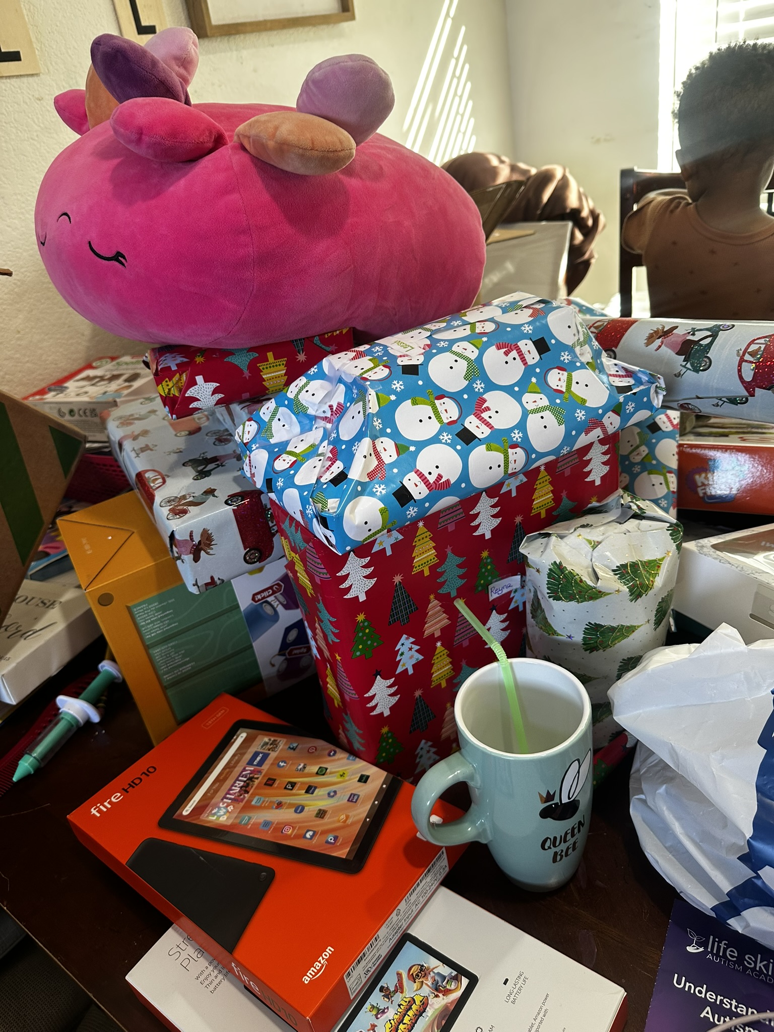Wrapped presents and a large plush toy gathered for delivery