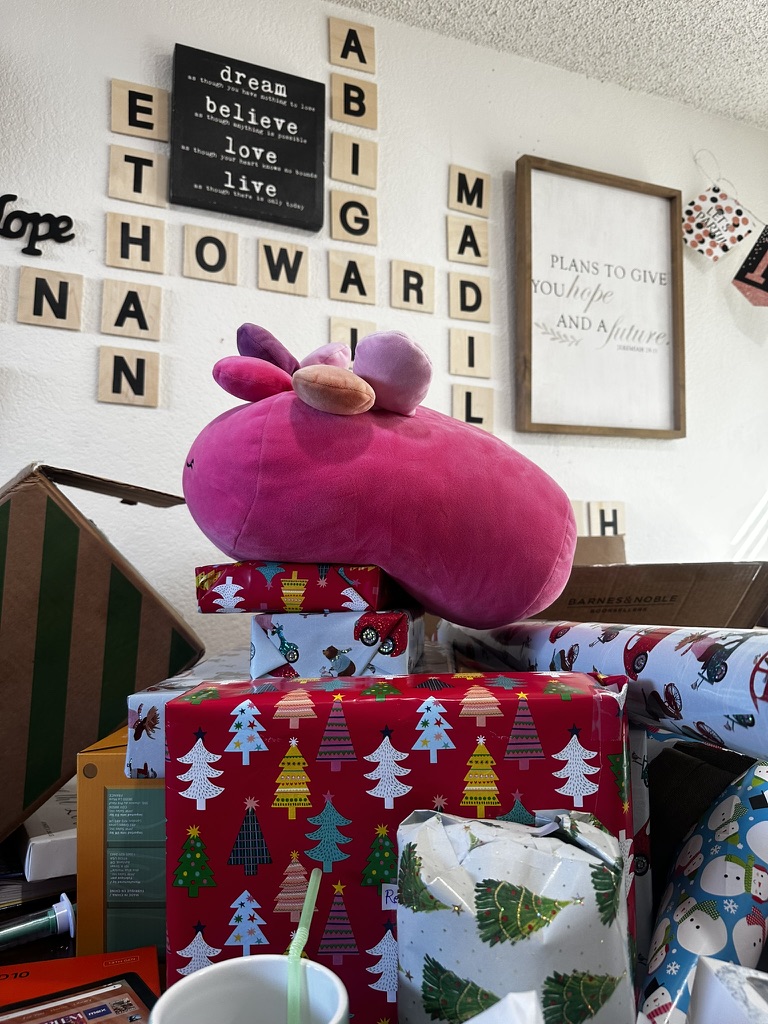 A large plush toy and wrapped gifts prepared for a family