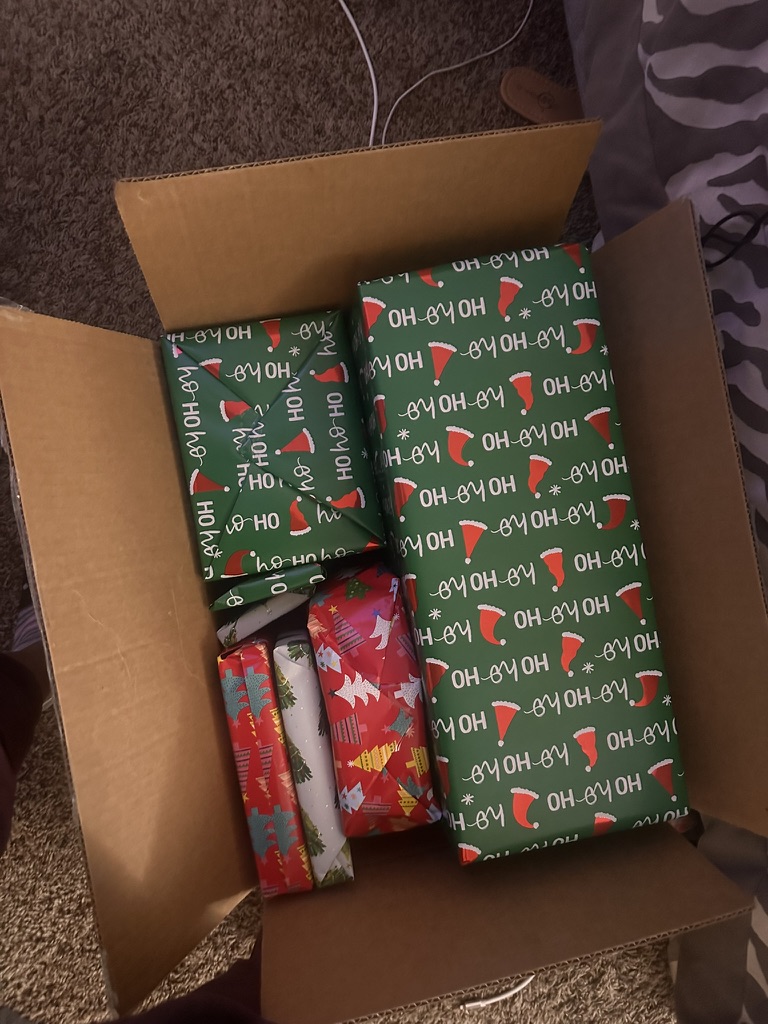 Individually wrapped Christmas presents packed in an open box