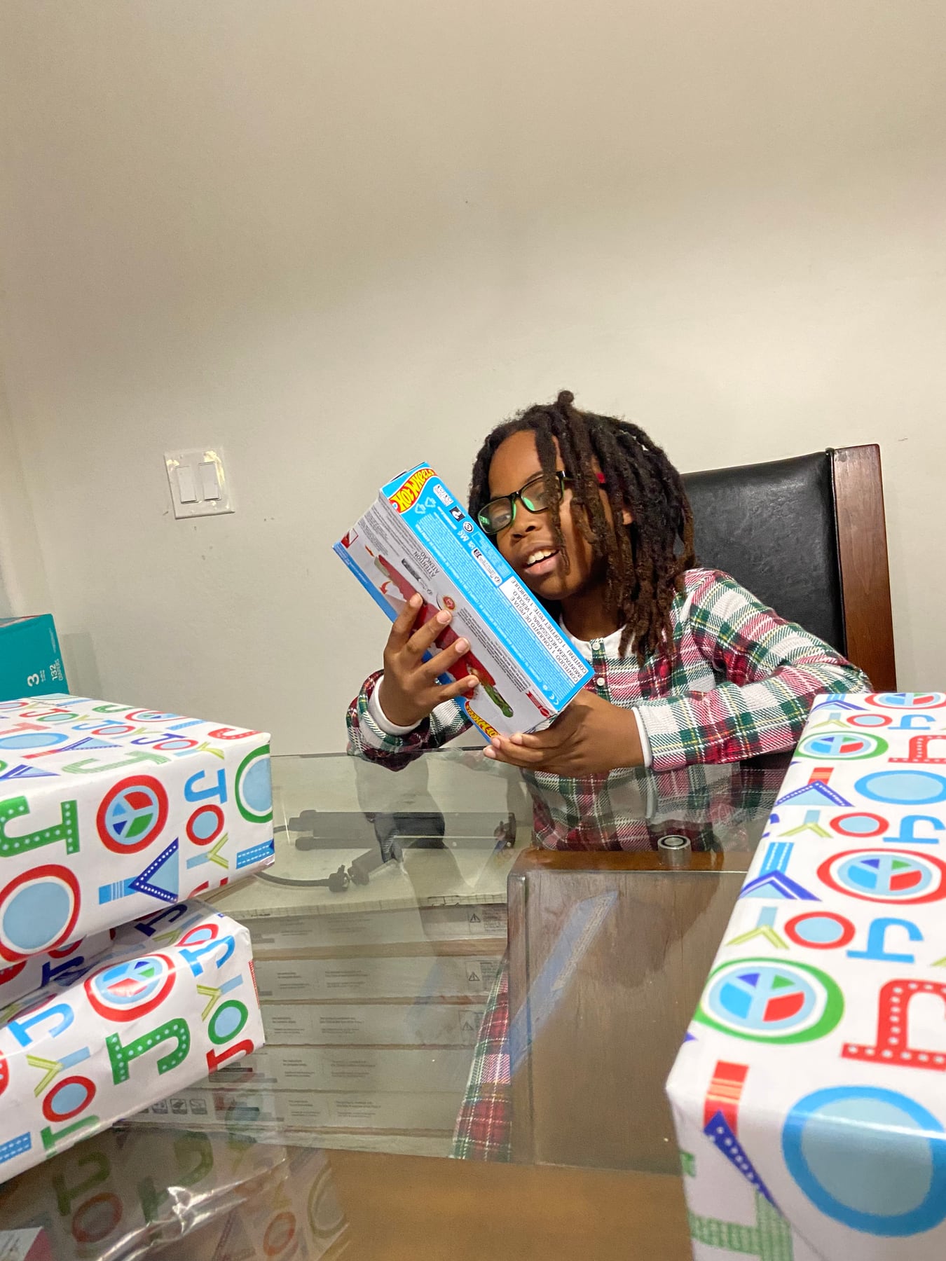 A child holding books and learning gifts received for Christmas