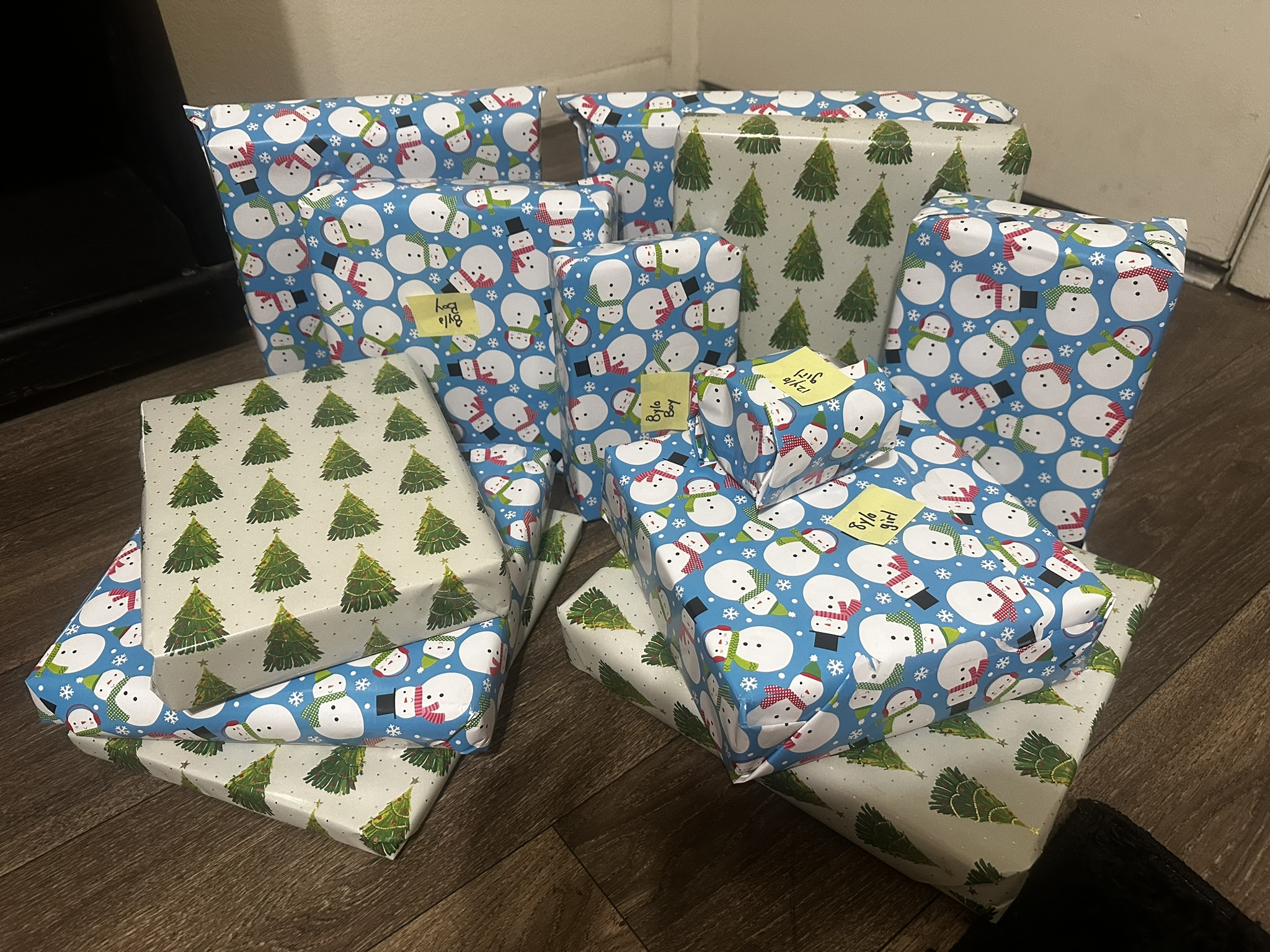 Blue snowman-wrapped gifts organized for children