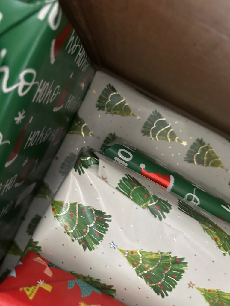 A close view of Christmas gifts being wrapped