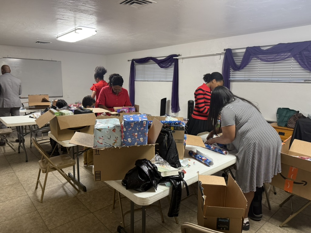 Volunteers wrapping personalized gifts together