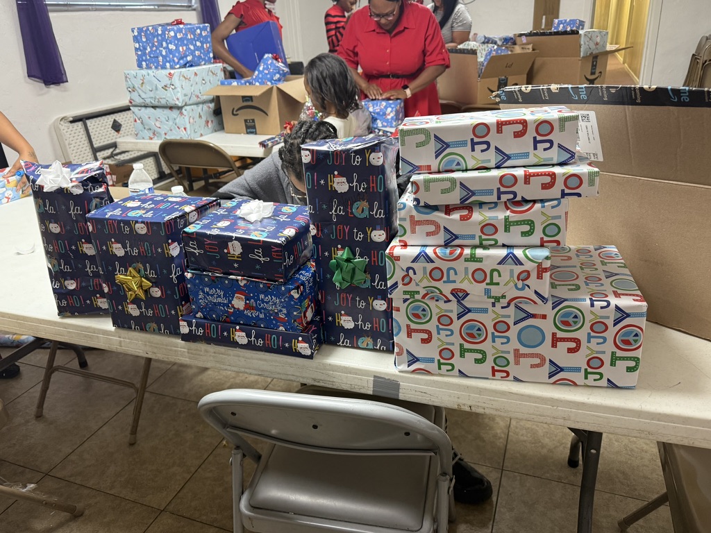 Stacks of wrapped presents on a volunteer work table
