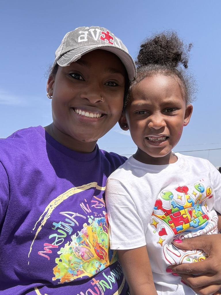 A family smiling together at the first community event