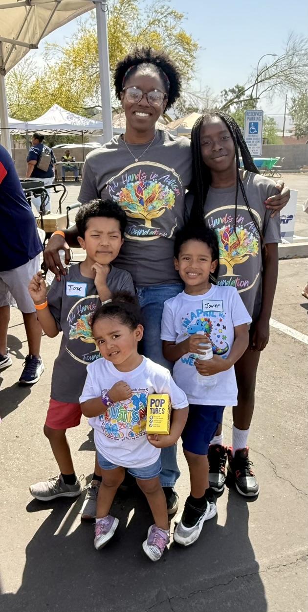 A foundation team member with four children at the first community event